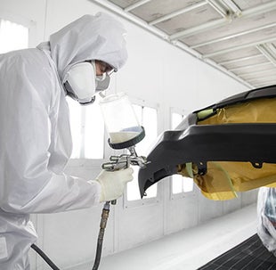 Collision Center Technician Painting a Vehicle | Sarasota Toyota in Sarasota FL