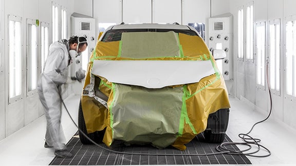 Collision Center Technician Painting a Vehicle | Sarasota Toyota in Sarasota FL